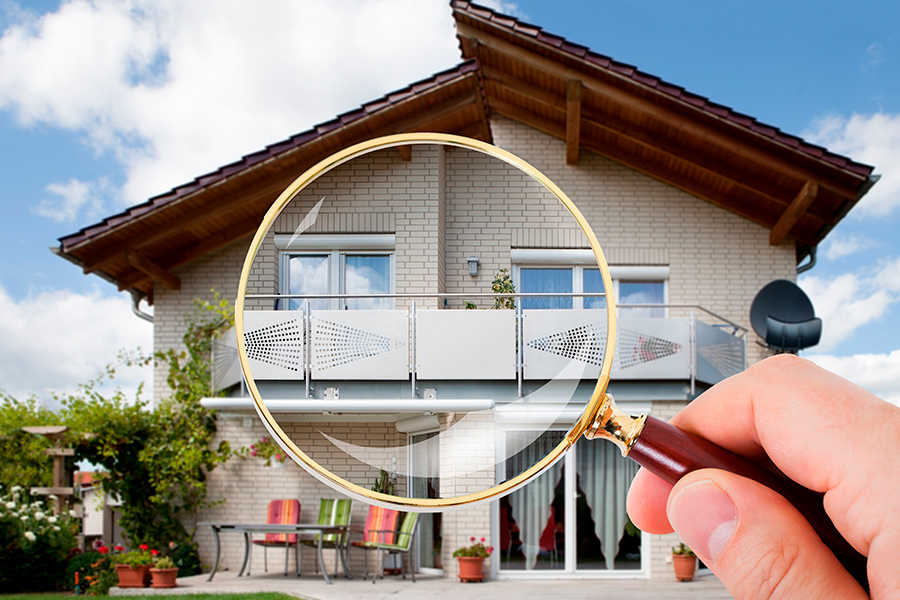 hand-with-magnifying-glass-outside-home-corry-pa