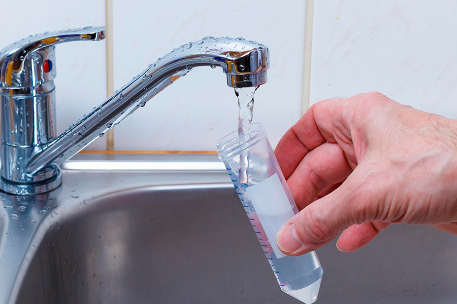 hand-putting-water-from-sink-in-test-tube-corry-pa